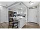 Modern kitchen with white cabinets, island, and stainless steel appliances at 5533 Satel Dr, Orlando, FL 32810