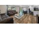 Open living space featuring hardwood floors and a cozy seating area at 5533 Satel Dr, Orlando, FL 32810
