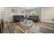 Living room with wood-look floors and comfy seating at 5533 Satel Dr, Orlando, FL 32810