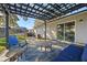 Cozy patio area with pergola, seating, and adjacent sliding glass door at 5533 Satel Dr, Orlando, FL 32810