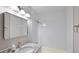 This bathroom offers a gray granite sink, vanity, a shower-tub combo with tiled walls and a square mirror at 632 Oakhurst St, Altamonte Springs, FL 32701