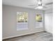 Bedroom features light gray walls, a ceiling fan, plank flooring, and two windows that allow plenty of natural light at 632 Oakhurst St, Altamonte Springs, FL 32701