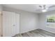 Cozy bedroom with white closet doors, a ceiling fan, light gray walls, and wood-look flooring at 632 Oakhurst St, Altamonte Springs, FL 32701