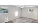 This bedroom features hardwood floors, neutral walls, two windows offering natural light, and base molding at 632 Oakhurst St, Altamonte Springs, FL 32701