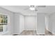 A bright bedroom featuring a modern ceiling fan, plank flooring, and a window with natural light at 632 Oakhurst St, Altamonte Springs, FL 32701