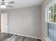 This bedroom offers neutral walls, hardwood flooring, a ceiling fan, and a window allowing natural light at 632 Oakhurst St, Altamonte Springs, FL 32701