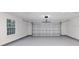 Clean two-car garage with white walls, a window, and sealed concrete floor at 632 Oakhurst St, Altamonte Springs, FL 32701
