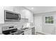 A bright kitchen featuring stainless appliances, granite counters and white cabinets at 632 Oakhurst St, Altamonte Springs, FL 32701
