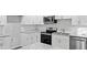 A well-lit kitchen with white cabinets, stainless steel appliances, granite countertops, and subway tile backsplash at 632 Oakhurst St, Altamonte Springs, FL 32701
