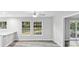 This living room features plank floors, neutral paint, windows with bright natural light, and access to additional rooms at 632 Oakhurst St, Altamonte Springs, FL 32701