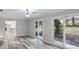 Stylish living room featuring modern floors, ceiling fan, and sliding doors to the backyard at 632 Oakhurst St, Altamonte Springs, FL 32701