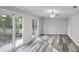 Modern living room with sleek flooring, ceiling fan, and sliding glass doors leading to the backyard at 632 Oakhurst St, Altamonte Springs, FL 32701