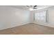 Bright bedroom with carpeted floor, window blinds, and ceiling fan at 1000 S Semoran Blvd # 814, Winter Park, FL 32792