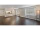 Spacious living room featuring dark laminate floors and an open kitchen concept at 1000 S Semoran Blvd # 814, Winter Park, FL 32792