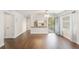 Bright living room with dark laminate wood floors and kitchen pass-through at 1000 S Semoran Blvd # 814, Winter Park, FL 32792
