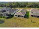 An aerial view showcasing a well-maintained lawn and the serene neighborhood surroundings of the property at 10157 Spring Lake Dr, Clermont, FL 34711