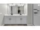 Bathroom featuring double sinks with modern faucets, tile floors, and a spacious walk-in shower at 10157 Spring Lake Dr, Clermont, FL 34711