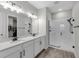 Contemporary bathroom boasts a double vanity, subway tile shower, and modern fixtures at 10157 Spring Lake Dr, Clermont, FL 34711