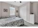 Bedroom featuring neutral walls, plush gray carpeting, a queen-sized bed, and a spacious double-door closet at 10157 Spring Lake Dr, Clermont, FL 34711
