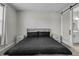 Bedroom with sliding barn door to ensuite bathroom, bedside tables, and carpet flooring at 10157 Spring Lake Dr, Clermont, FL 34711