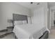 Bedroom with gray tufted headboard, carpet flooring, and a mirrored closet at 10157 Spring Lake Dr, Clermont, FL 34711