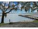 Wooden dock extending into calm water at 10157 Spring Lake Dr, Clermont, FL 34711