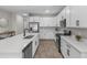 Modern kitchen with quartz countertops, stainless steel appliances, and sleek white cabinetry at 10157 Spring Lake Dr, Clermont, FL 34711