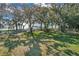 Picturesque lake view with trees, a playground and glimpses of a dock at 10157 Spring Lake Dr, Clermont, FL 34711