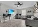 Inviting living room with wood-look tile, ceiling fan, and neutral paint, offering a comfortable and stylish space at 10157 Spring Lake Dr, Clermont, FL 34711