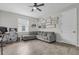 Inviting living room with wood-look tile, ceiling fan, and neutral paint, offering a comfortable and stylish space at 10157 Spring Lake Dr, Clermont, FL 34711