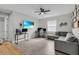 Inviting living room with wood-look tile, ceiling fan, and neutral paint, offering a comfortable and stylish space at 10157 Spring Lake Dr, Clermont, FL 34711