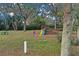 Playground equipment amongst mature trees at 10157 Spring Lake Dr, Clermont, FL 34711