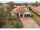 Single-Gathering home with tile roof, driveway, and landscaped lawn at 112 San Lucia Dr, Debary, FL 32713