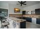 Outdoor kitchen with granite countertop and bar seating at 12540 Park Avenue, Windermere, FL 34786
