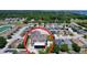 Aerial view of a backyard with a screened porch in a suburban neighborhood at 1727 Wood Path, Auburndale, FL 33823