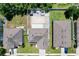 Aerial view showcasing backyard layout with a patio and manicured landscaping in a residential neighborhood at 1727 Wood Path, Auburndale, FL 33823