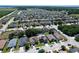 Expansive aerial view of a residential community with lush landscaping and manicured lawns extending to the horizon at 1727 Wood Path, Auburndale, FL 33823