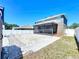 Expansive backyard featuring a screened-in porch, white rock bed, partial grass, and privacy fence at 1727 Wood Path, Auburndale, FL 33823