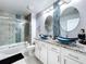 This updated bathroom has a glass shower, dual sink vanity with granite counters and vessel sinks at 1727 Wood Path, Auburndale, FL 33823