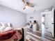 Guest room featuring a ceiling fan, and a white desk with a computer, and an entrance to a bedroom at 1727 Wood Path, Auburndale, FL 33823