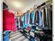 Organized walk-in closet with shelving, hanging rods, and ample storage space for clothing and accessories at 1727 Wood Path, Auburndale, FL 33823