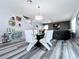 Dining area featuring modern lighting, gray floors, and staircase at 1727 Wood Path, Auburndale, FL 33823