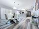 Dining area features modern lighting and gray floors, open to kitchen at 1727 Wood Path, Auburndale, FL 33823