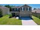 Charming two-story home featuring stone accents, a well-maintained lawn, and a welcoming entrance at 1727 Wood Path, Auburndale, FL 33823