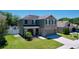 Two-story home featuring stone accents, well-manicured lawn, and a two-car garage at 1727 Wood Path, Auburndale, FL 33823