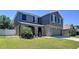 Attractive home featuring stone accents, a manicured lawn, and dark shutters enhancing curb appeal at 1727 Wood Path, Auburndale, FL 33823