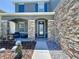 Inviting front entry with stone pillars and well-maintained landscaping at 1727 Wood Path, Auburndale, FL 33823
