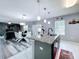 Granite island with pendant lighting, open layout to living spaces at 1727 Wood Path, Auburndale, FL 33823