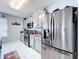 This kitchen is equipped with granite countertops, stainless steel appliances, and tiled backsplash at 1727 Wood Path, Auburndale, FL 33823