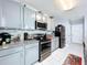 Kitchen with granite counters, stainless appliances, and lots of cabinet storage at 1727 Wood Path, Auburndale, FL 33823